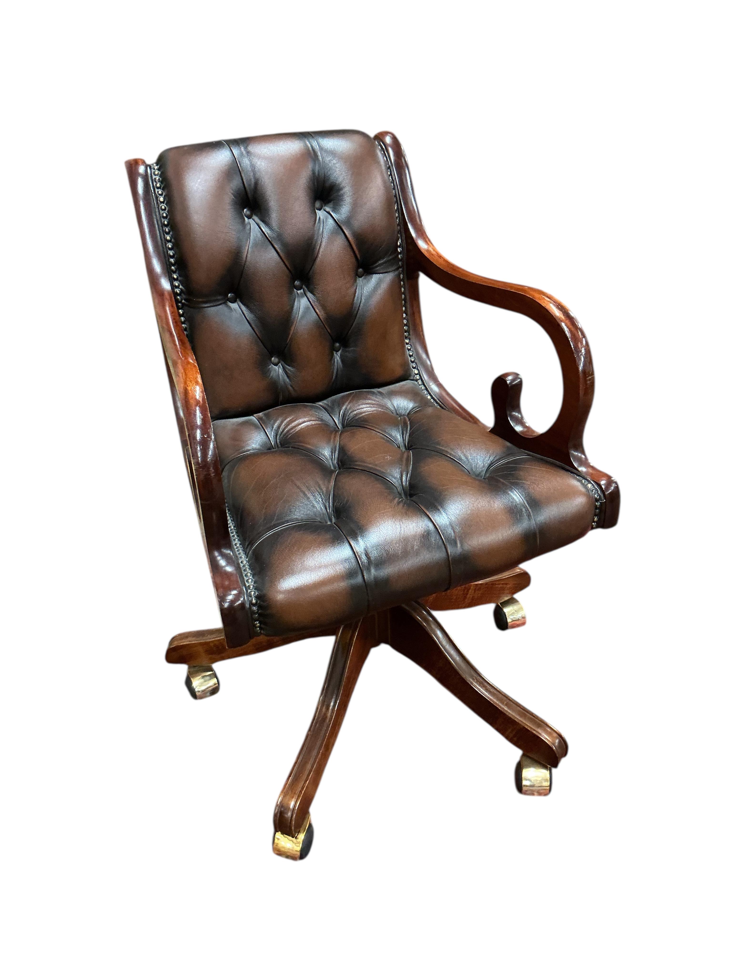 A reproduction buttoned brown leather swivel desk chair, width 51cm, depth 47cm, height 82cm